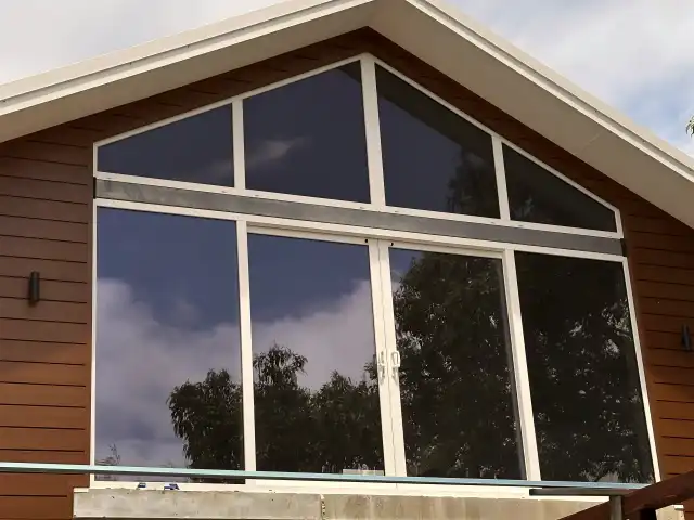 Raked gable window with fixed triangular glazing panels